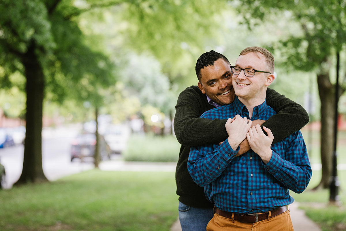 Boat rides and dog walks during loving Baltimore engagement photos two grooms neighborhood