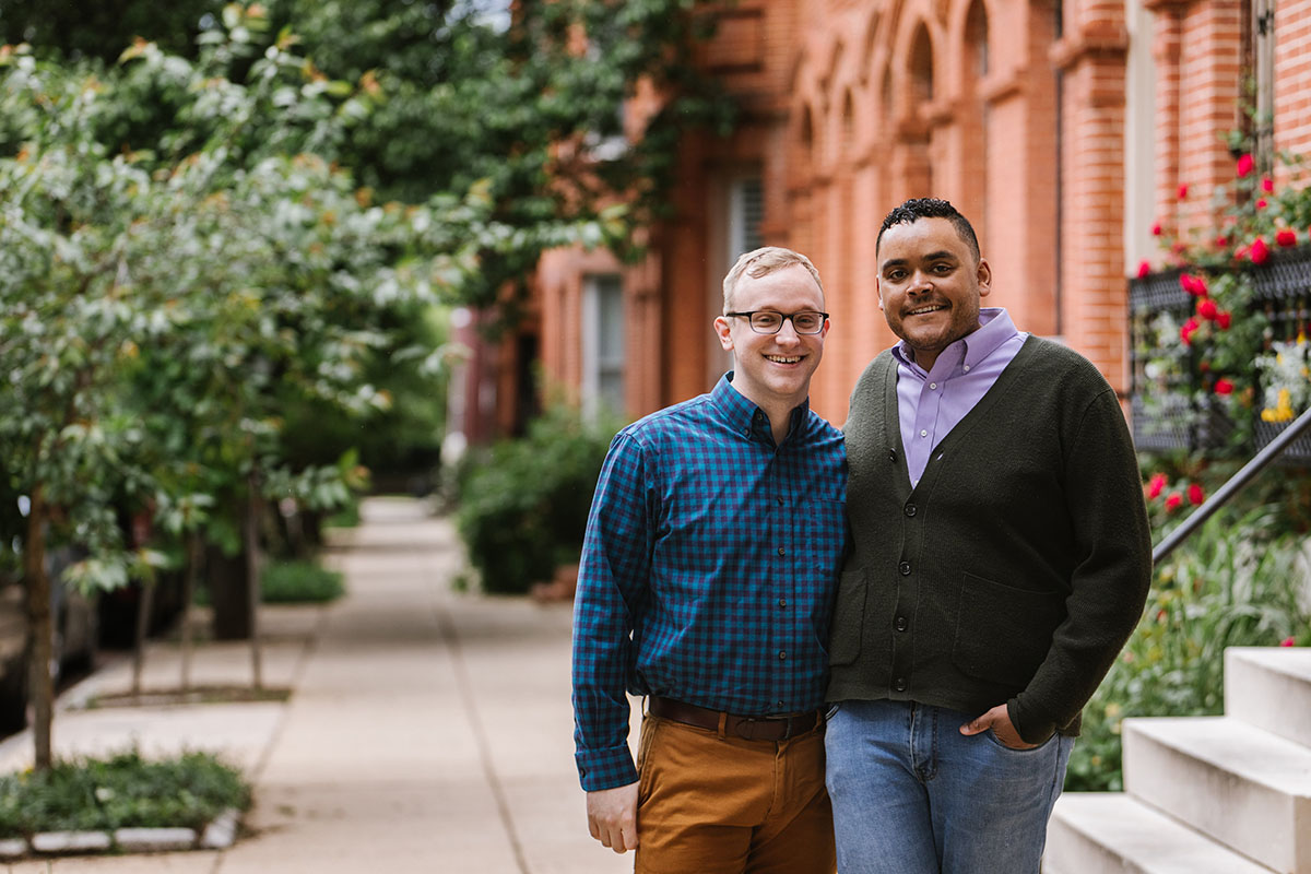 Boat rides and dog walks during loving Baltimore engagement photos two grooms neighborhood
