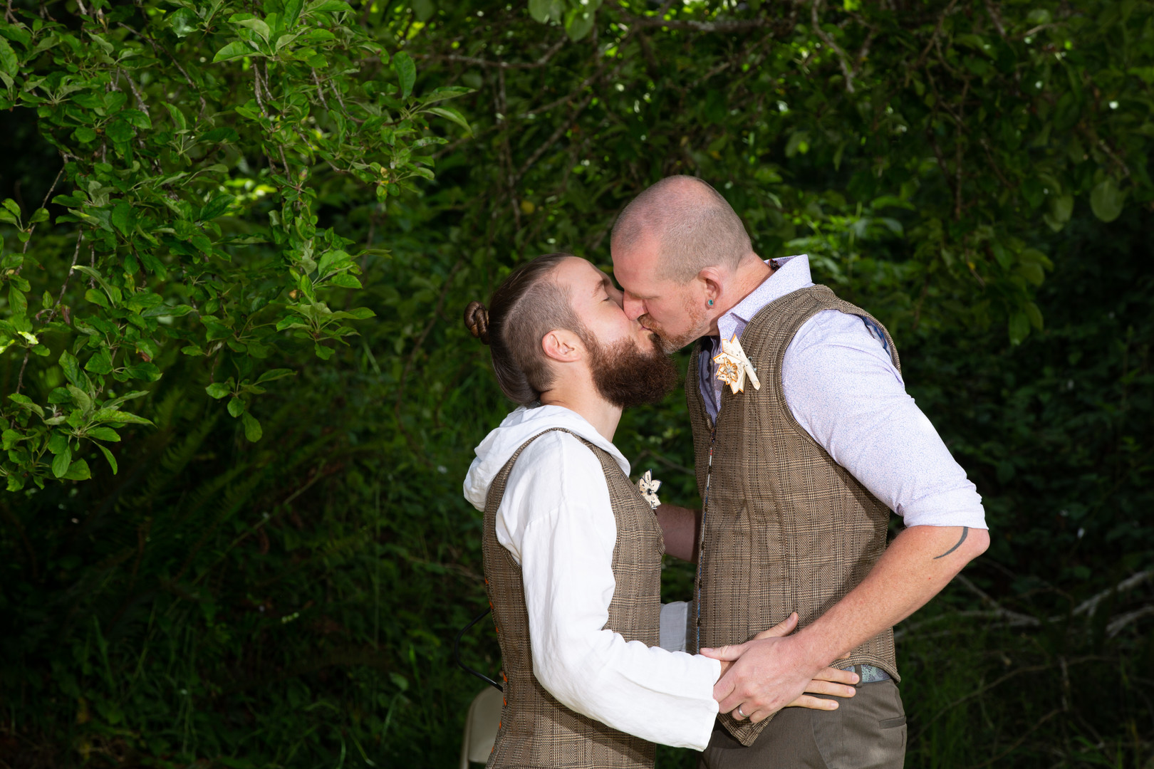 Bohemian orchard farm spring wedding two grooms outdoor farm DIY wedding kiss