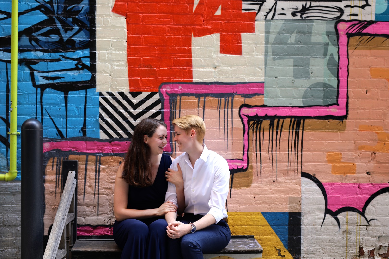 Colorful engagement photos in The Belt in Detroit, Michigan two brides LGBTQ downtown graffiti