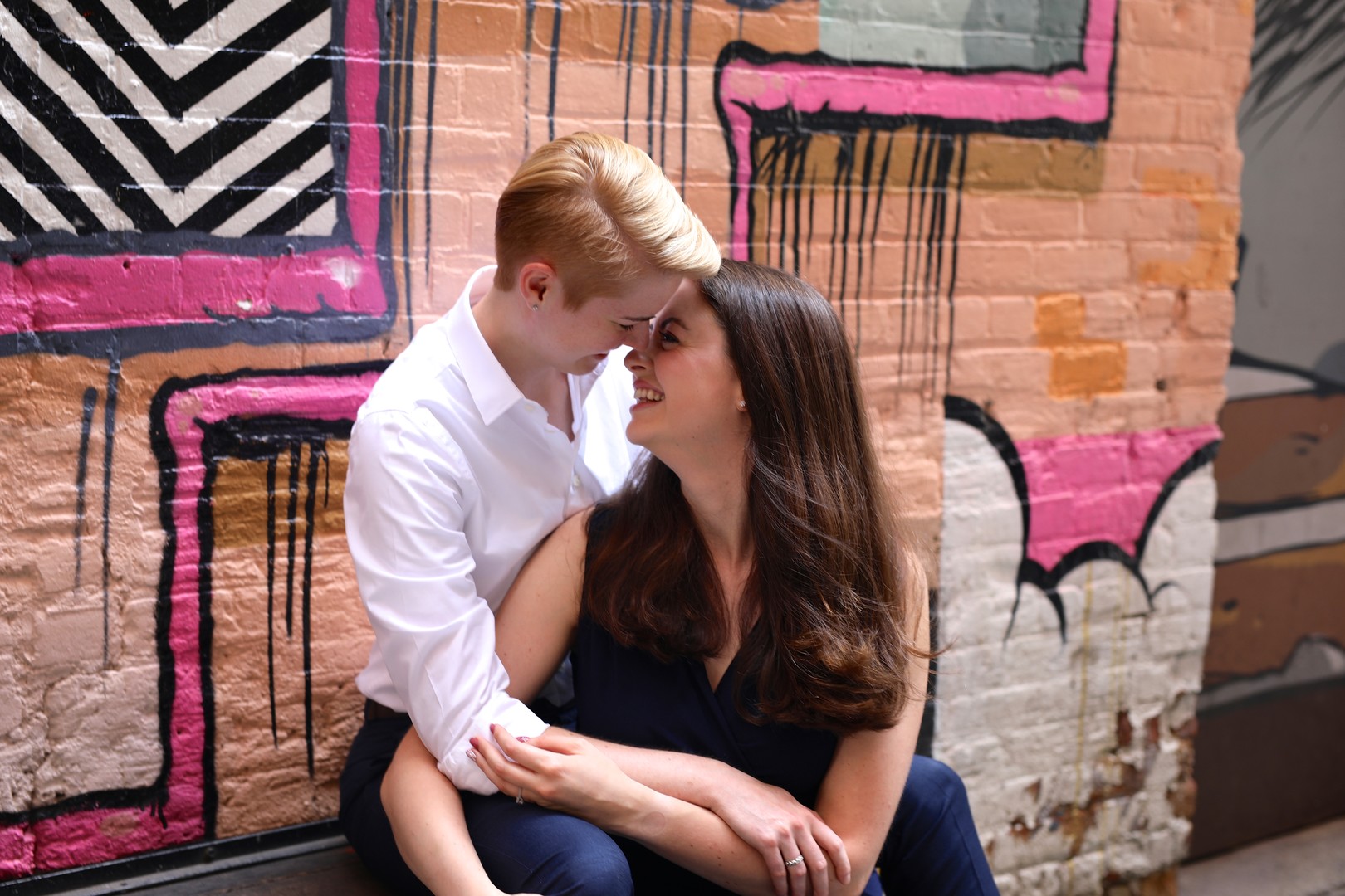 Colorful engagement photos in The Belt in Detroit, Michigan two brides LGBTQ downtown graffiti
