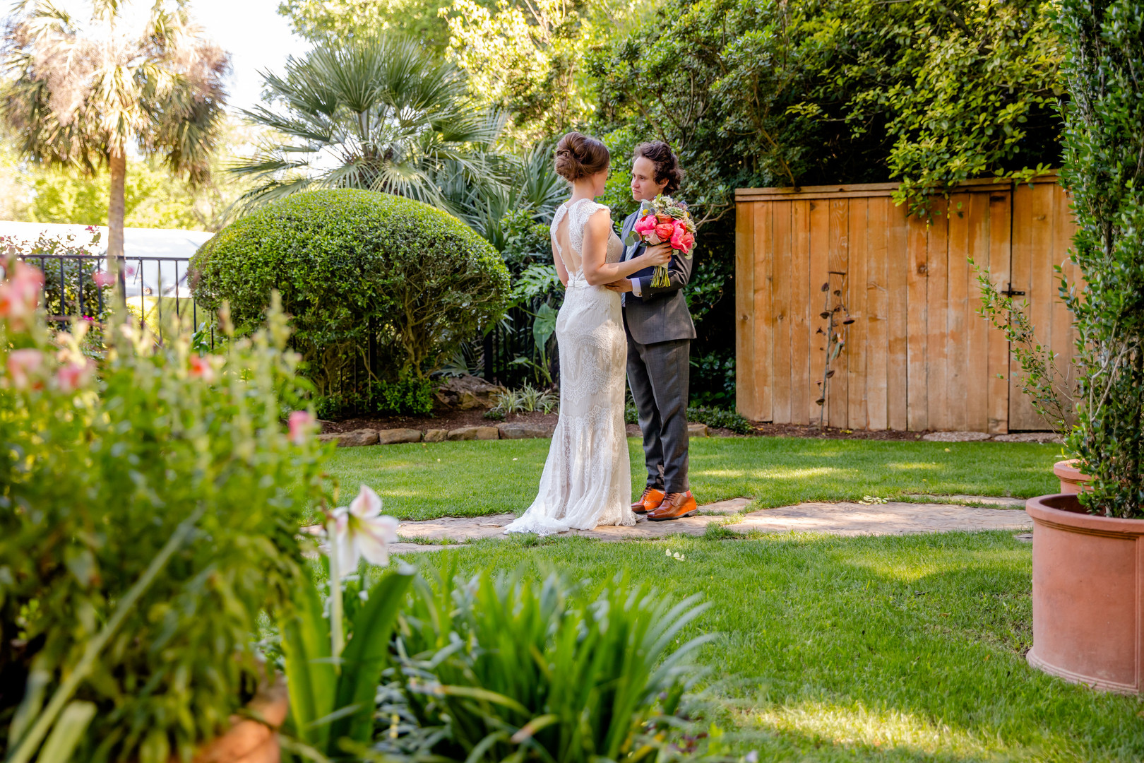 Colorful, whimsical spring backyard wedding in Austin, Texas two brides white dress black tux