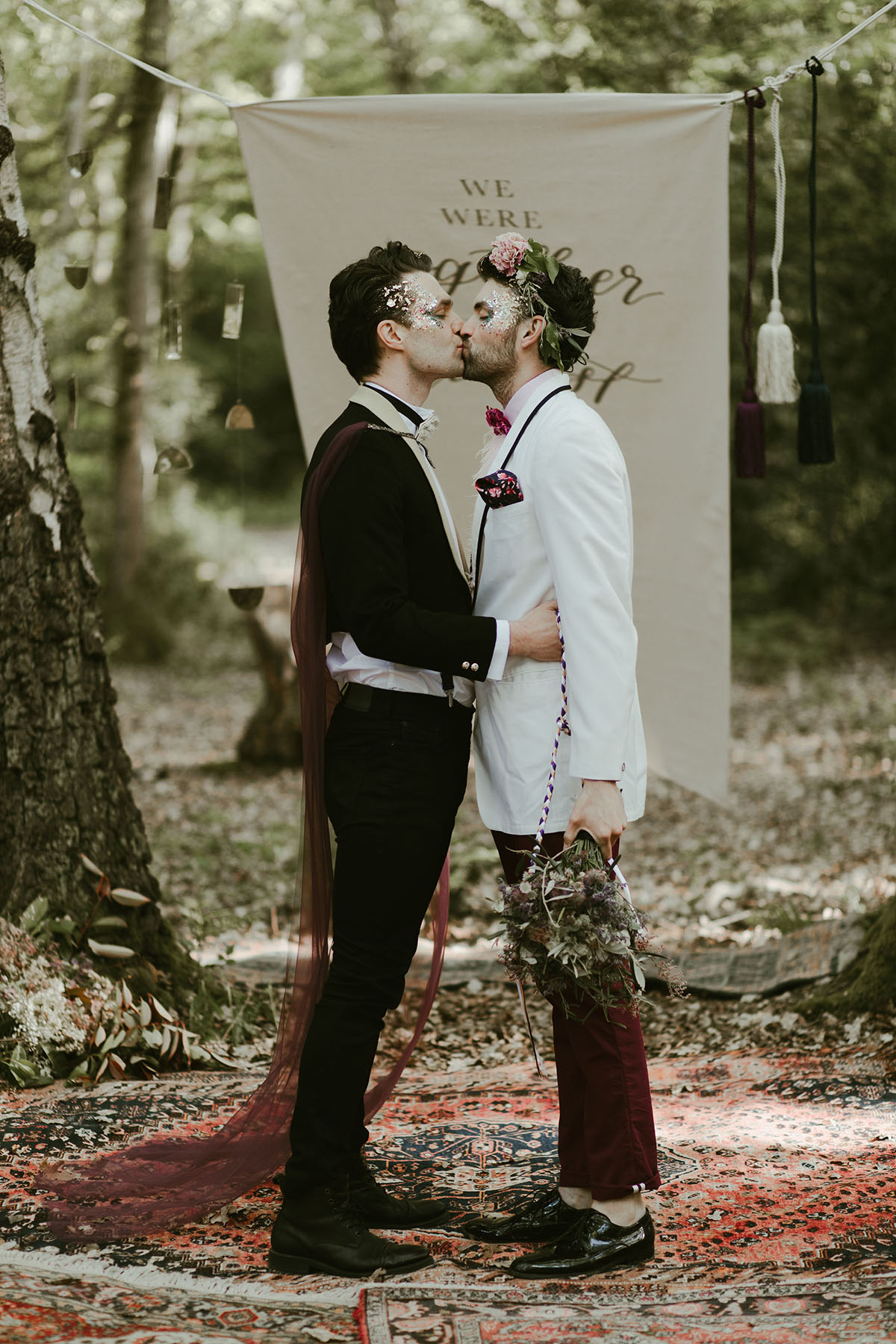 Creative wildflower elopement inspiration in the woods two grooms flowers floral veil suits creative unique styled shoot kiss