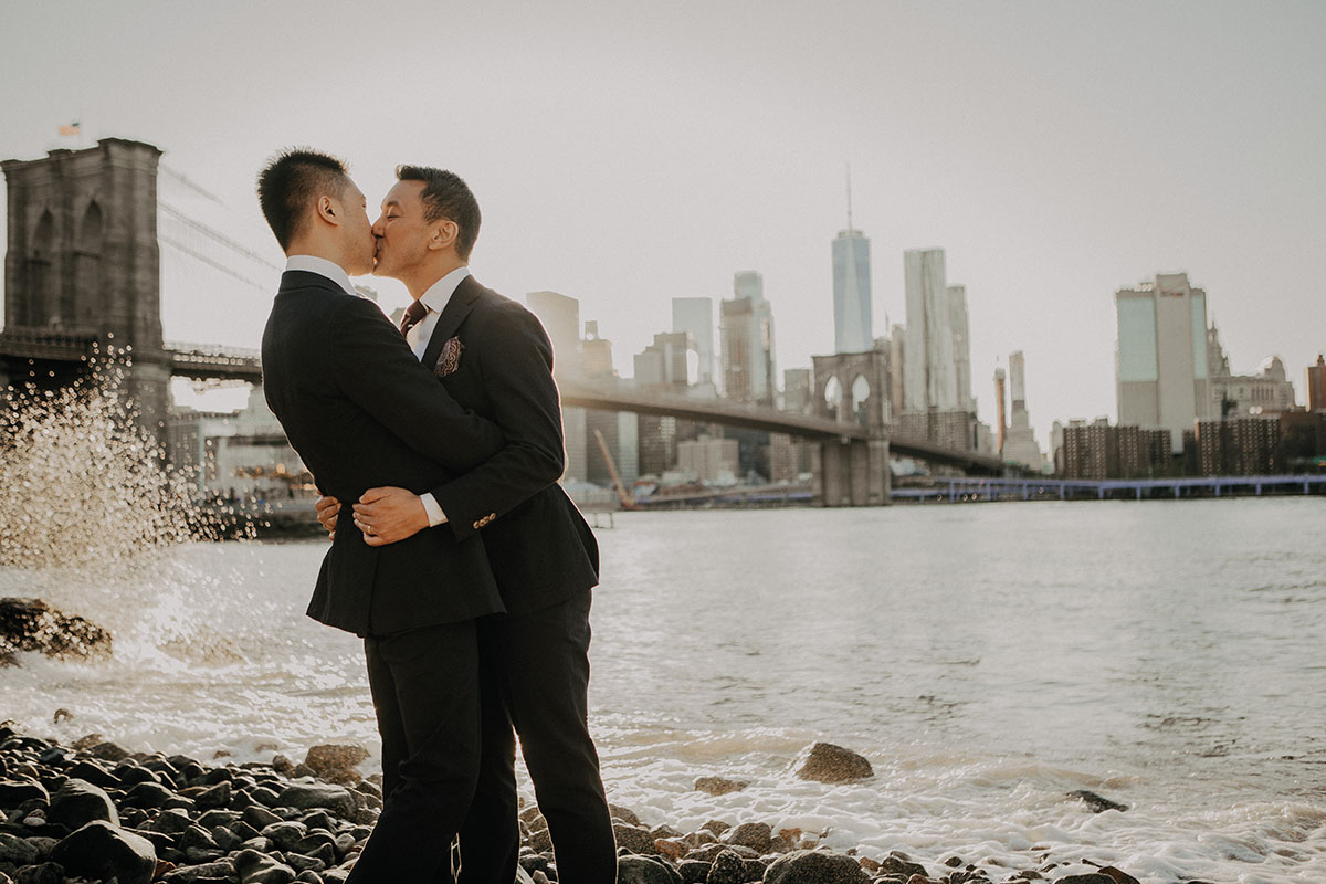 Elegant, fun engagement photos at Central Park with rainbow bubbles two grooms purple tux blue tux bow ties New york skyline