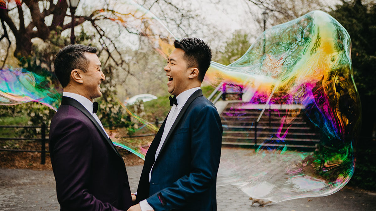 Elegant, fun engagement photos at Central Park with rainbow bubbles