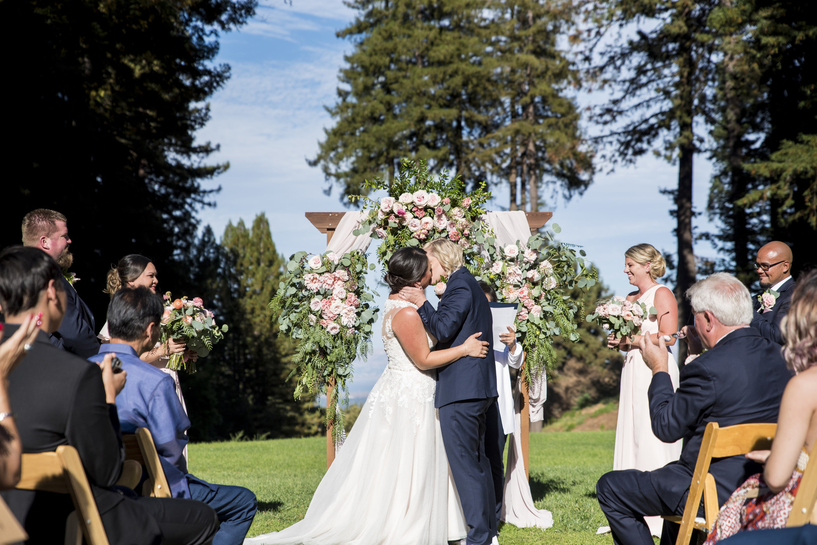 Garden wedding at the Mountain Terrace in Woodside, California two brides white dress tuxedo kiss just married