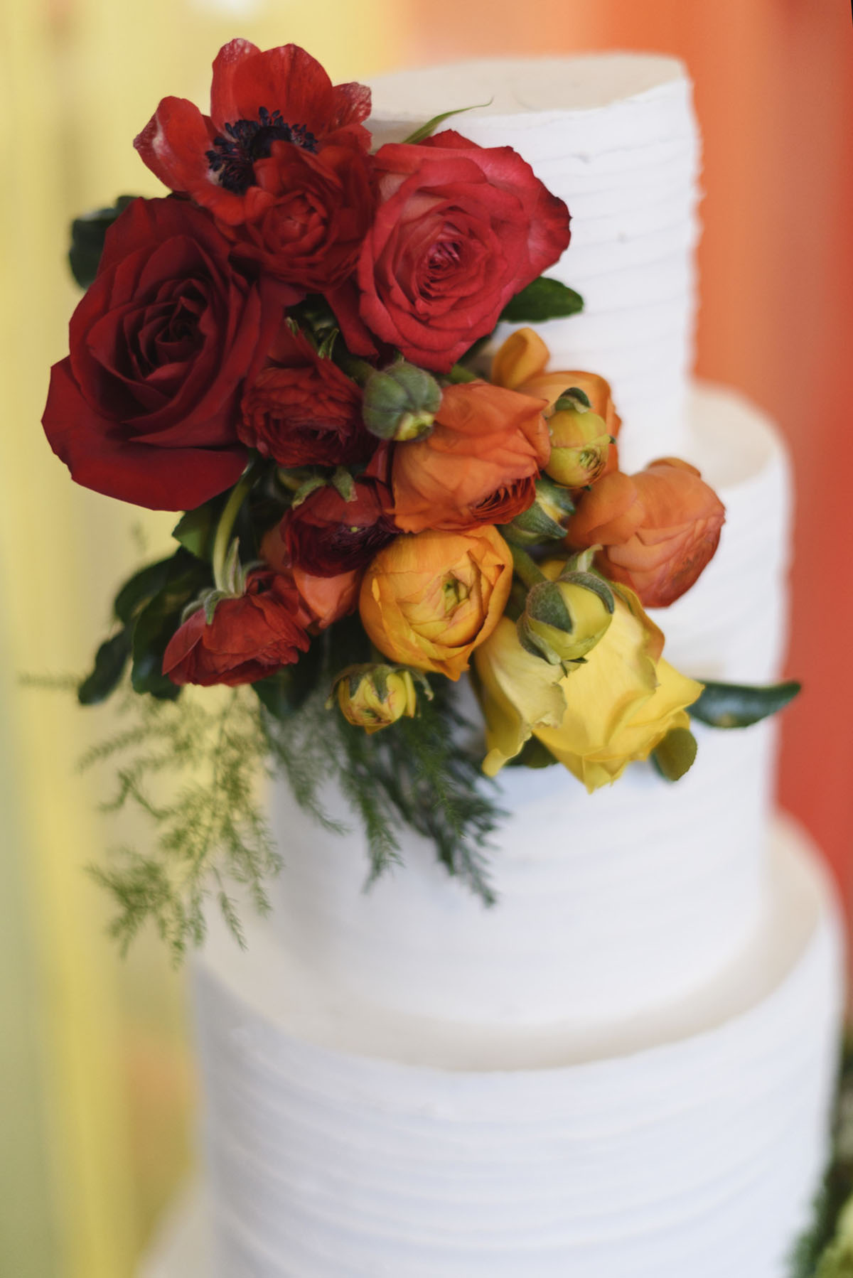 Orange winter elopement inspiration two grooms February wedding bright floral cake