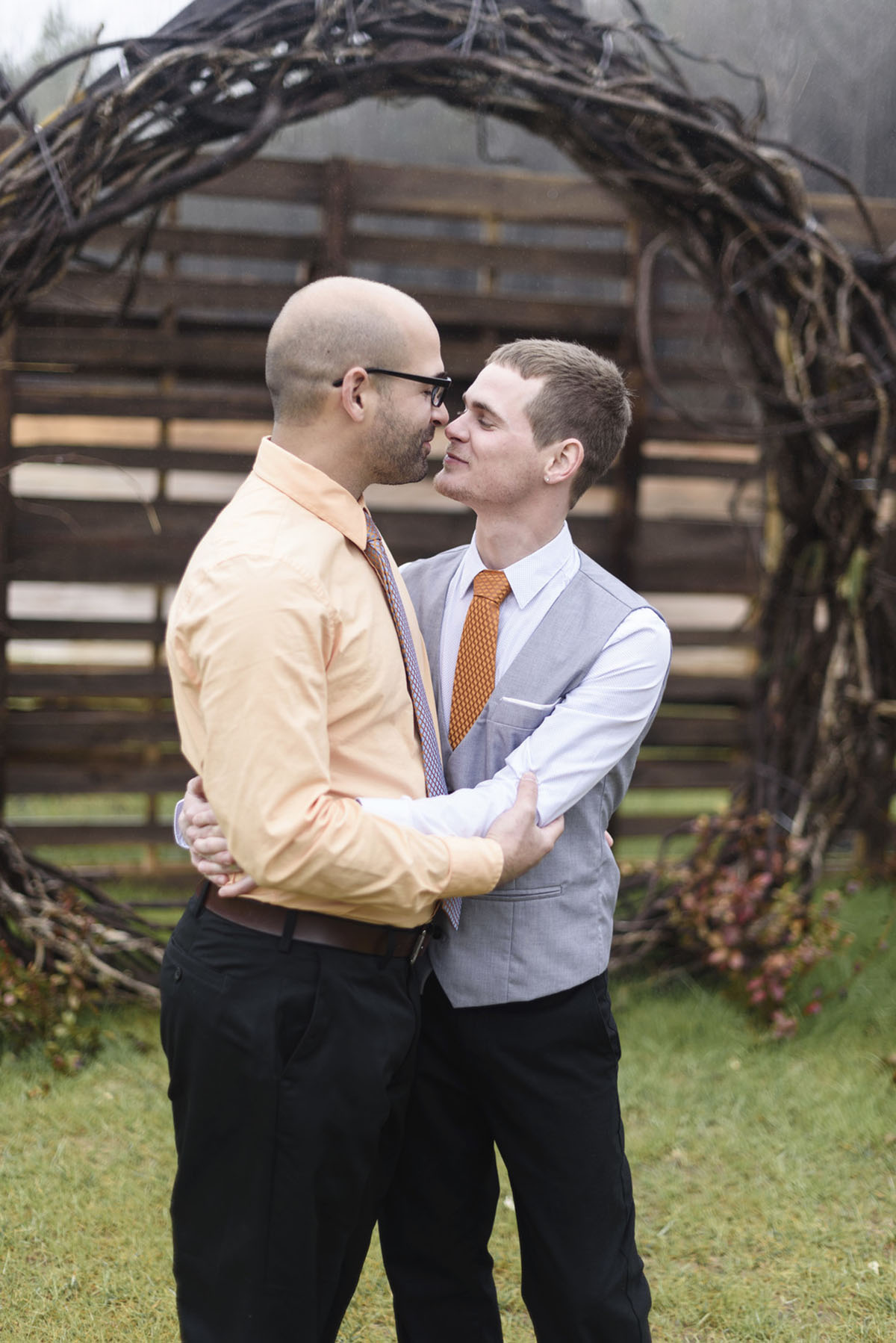 Orange winter elopement inspiration two grooms February wedding kiss