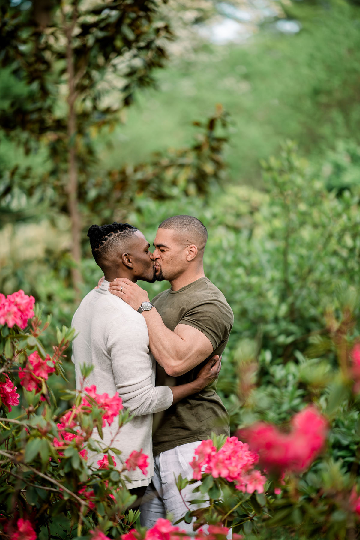 Vibrant, affectionate Van Vleck House and Gardens engagement photos two grooms outside Montclair New jersey cuddling kissing