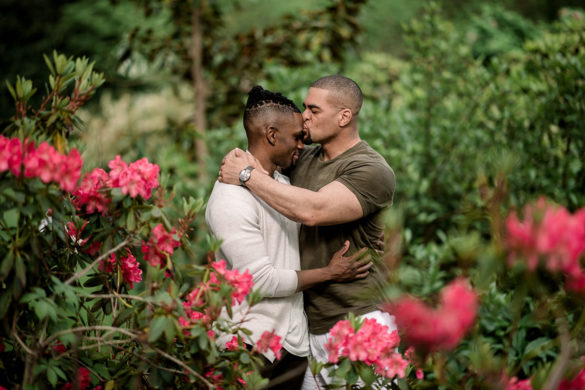 Vibrant, affectionate Van Vleck House and Gardens engagement photos two grooms outside Montclair New jersey cuddling flowers