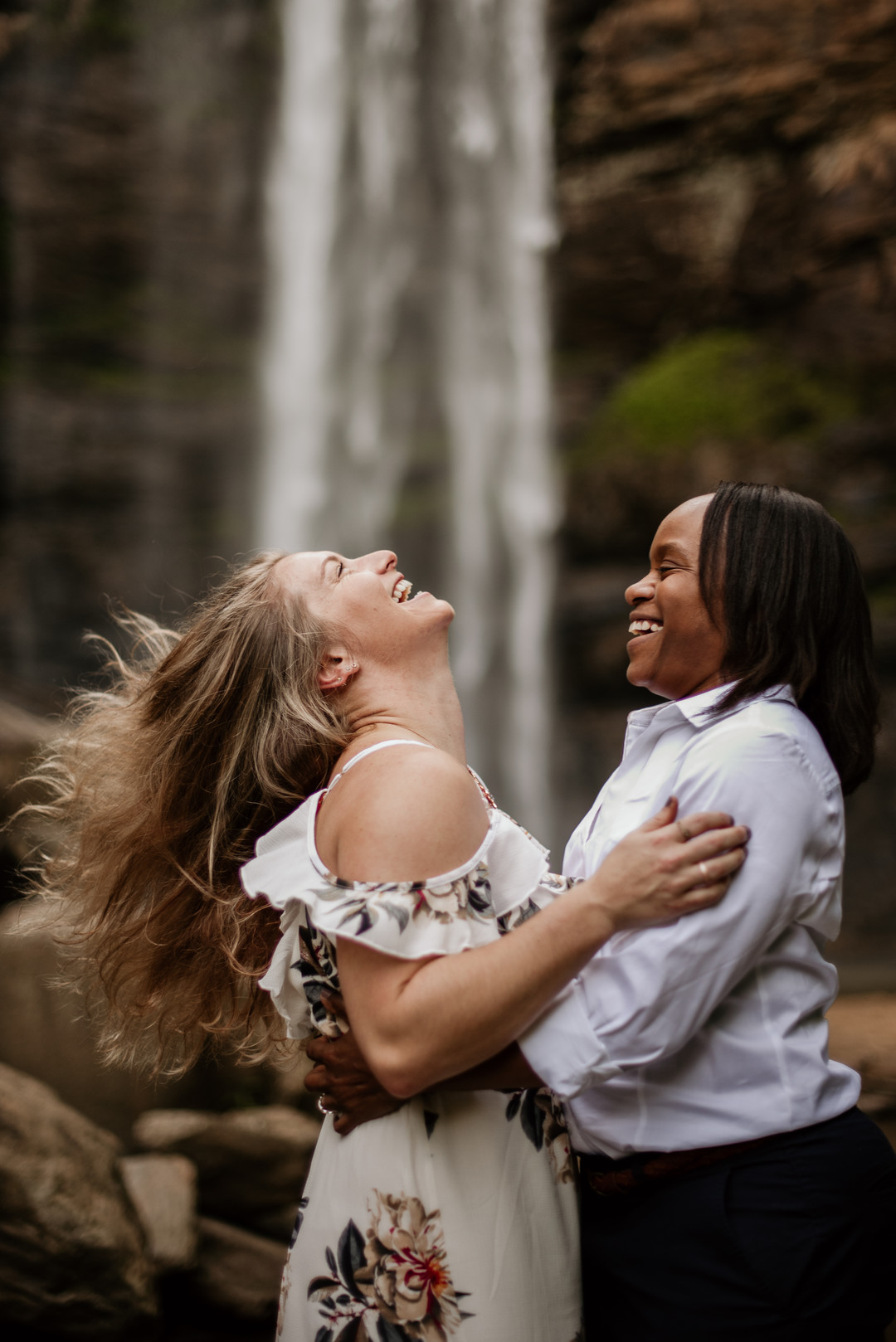Waterfall adventure engagement photos at Toccoa Falls two brides fun laughing