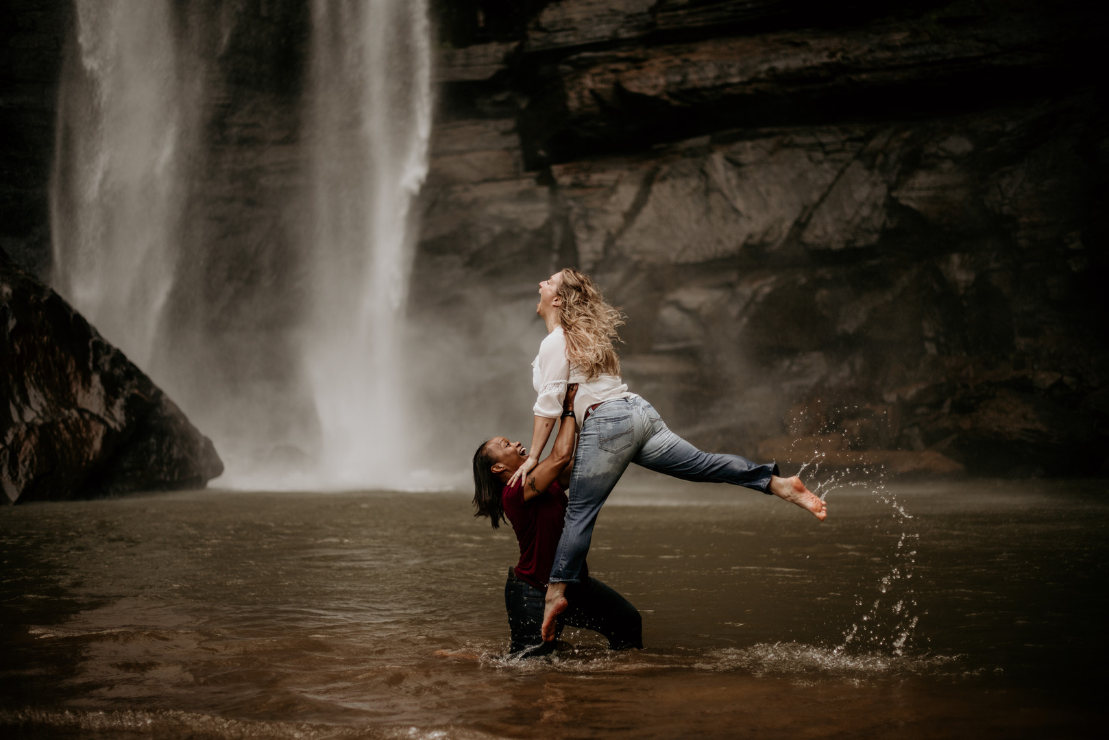 Waterfall adventure engagement photos at Toccoa Falls two brides fun lifting