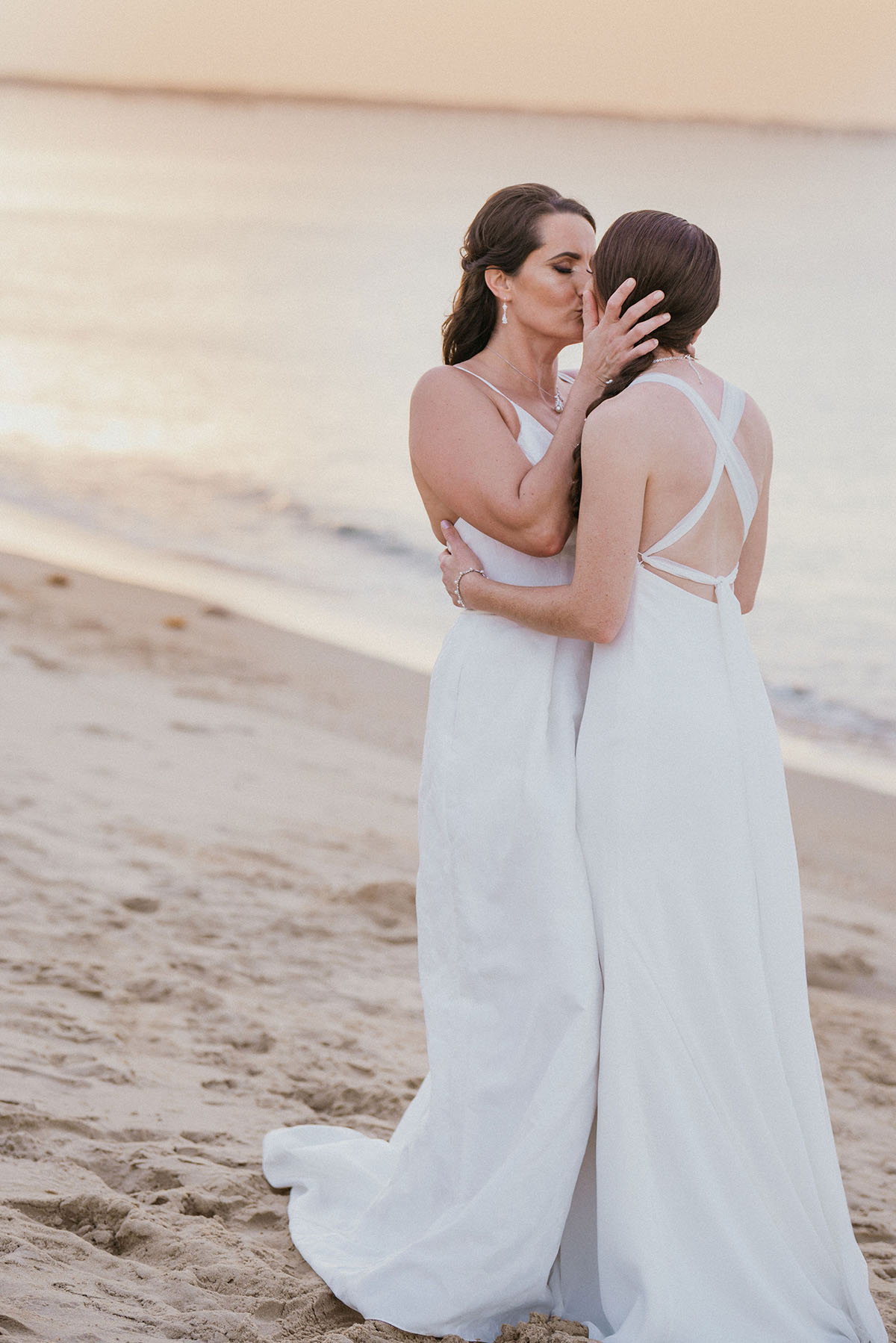 Beach wedding at First Landing State Park in Virginia Beach, Virginia LGBTQ+ weddings lesbian wedding two brides beach ocean fall wedding kiss