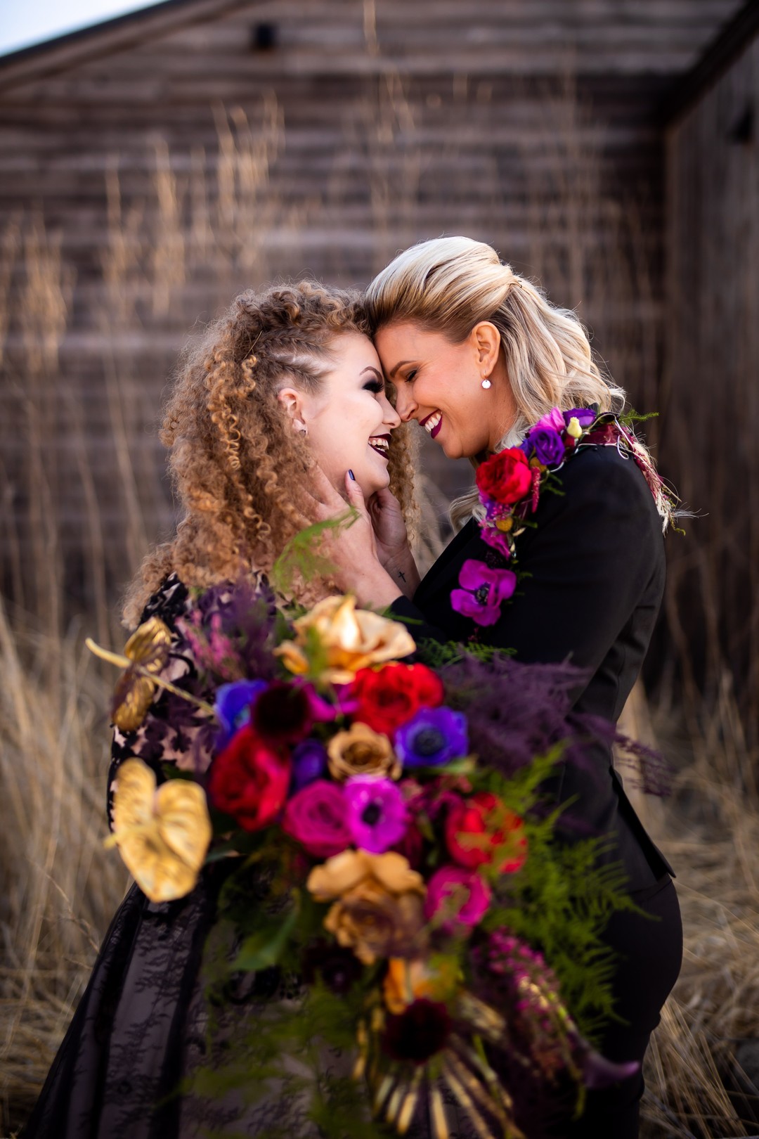 Colorful flowers brighten this dark, moody elopement inspiration LGBTQ+ weddings black wedding dress pantsuit two brides lesbian wedding inspiration bouquet