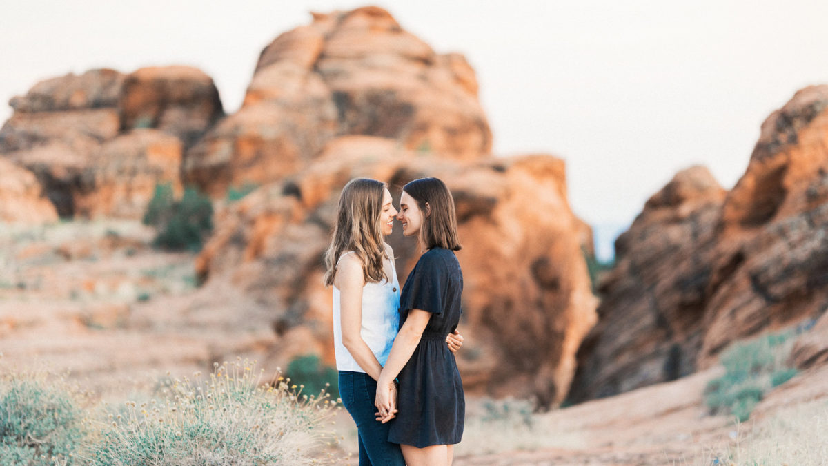 Engagement photos on red rock sandstone cliffs of Snow Canyon
