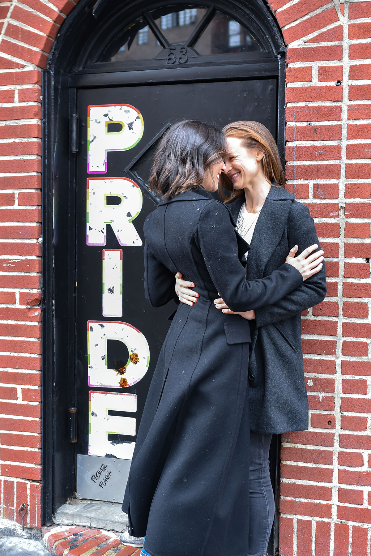 Fun engagement photos at Three Lives & Co. bookstore LGBTQ+ engagement same-sex engagement New York City bookstore rainy day