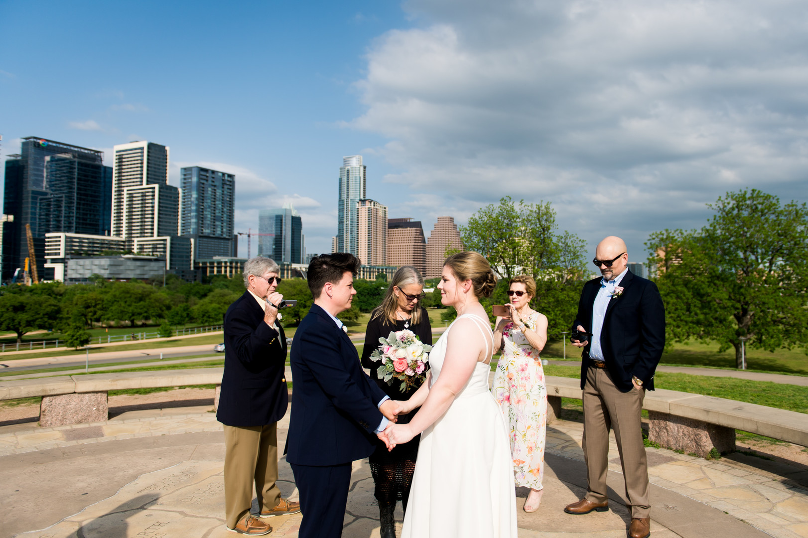 Intimate spring wedding at Butler Park in Austin, Texas LGBTQ+ weddings lesbian wedding two brides white dress navy blue suit vows