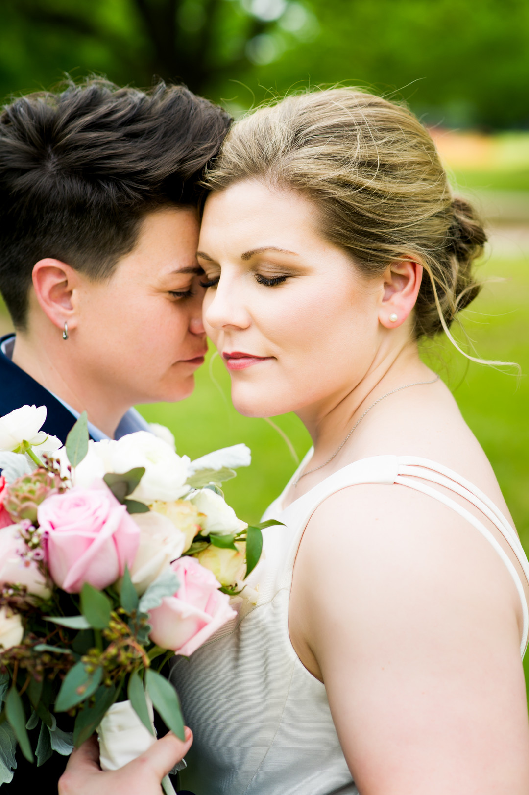 Intimate spring wedding at Butler Park in Austin, Texas LGBTQ+ weddings lesbian wedding two brides white dress navy blue suit