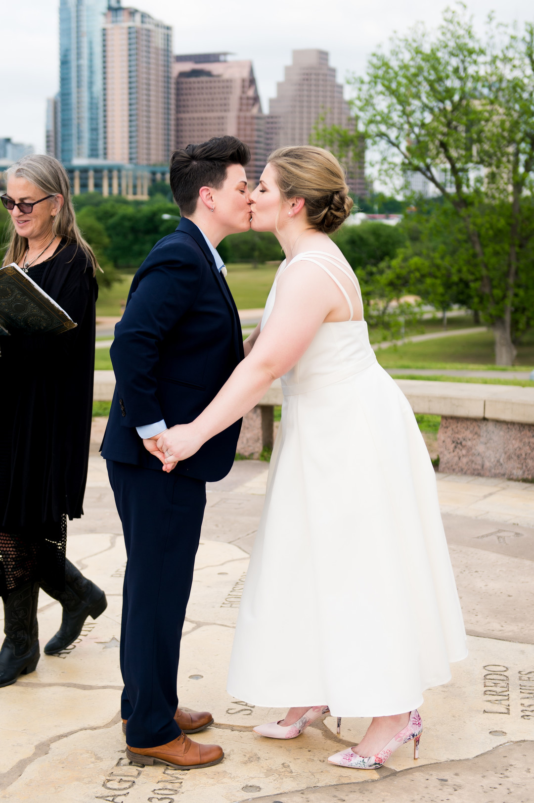 Intimate spring wedding at Butler Park in Austin, Texas LGBTQ+ weddings lesbian wedding two brides white dress navy blue suit kiss vows