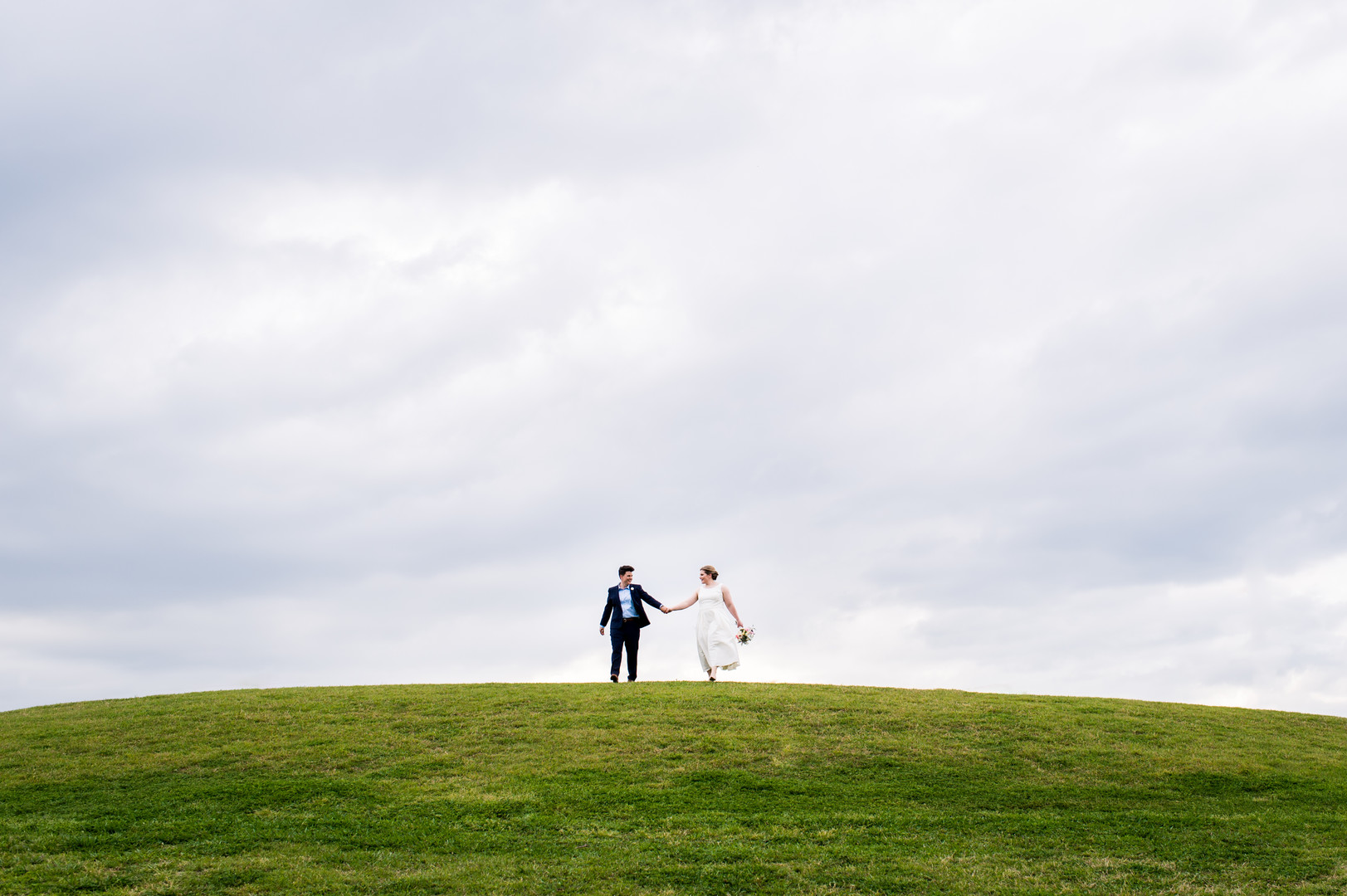 Intimate spring wedding at Butler Park in Austin, Texas LGBTQ+ weddings lesbian wedding two brides white dress navy blue suit hill