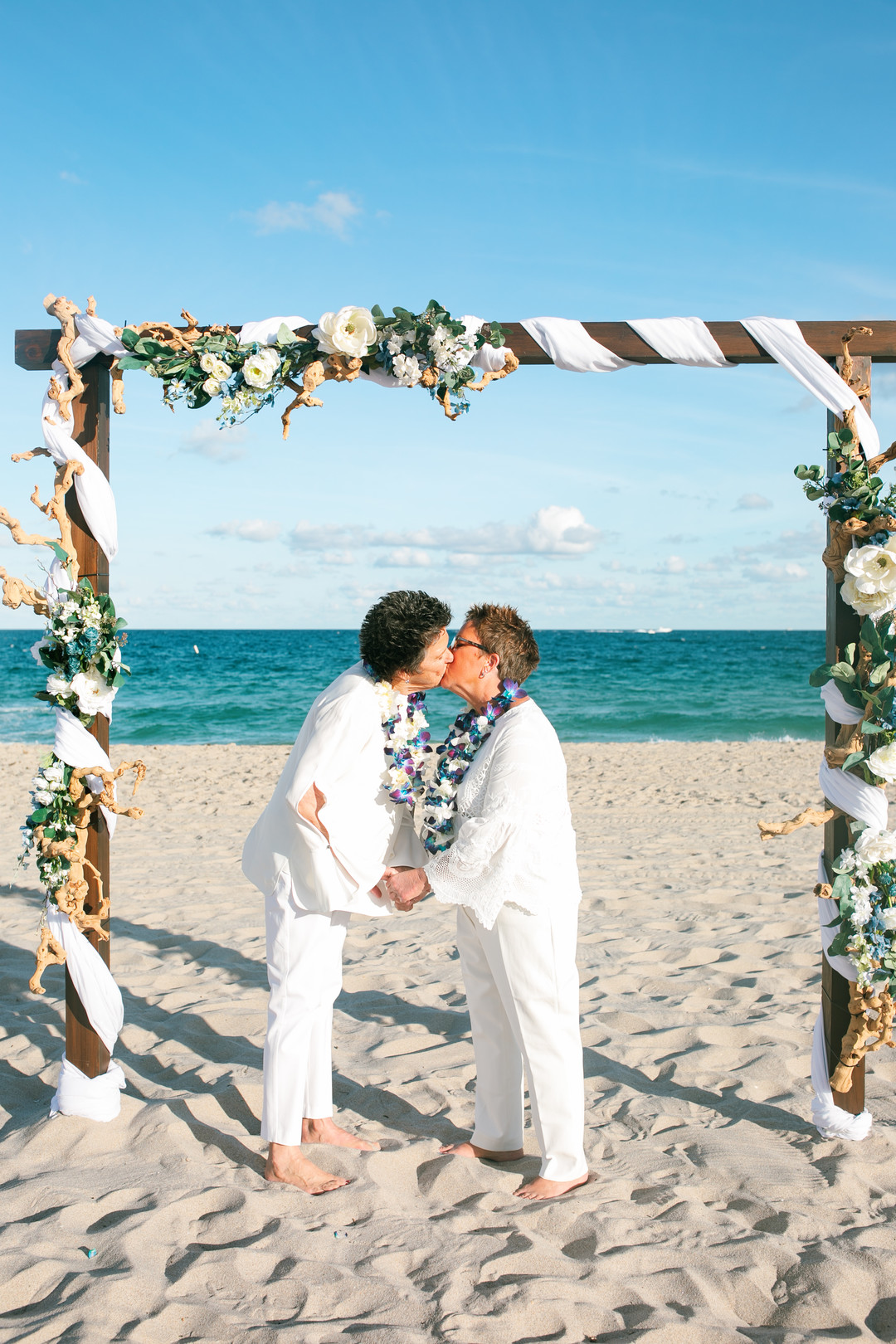 Romantic beach wedding in Fort Lauderdale, Florida two brides lesbian wedding vows kiss