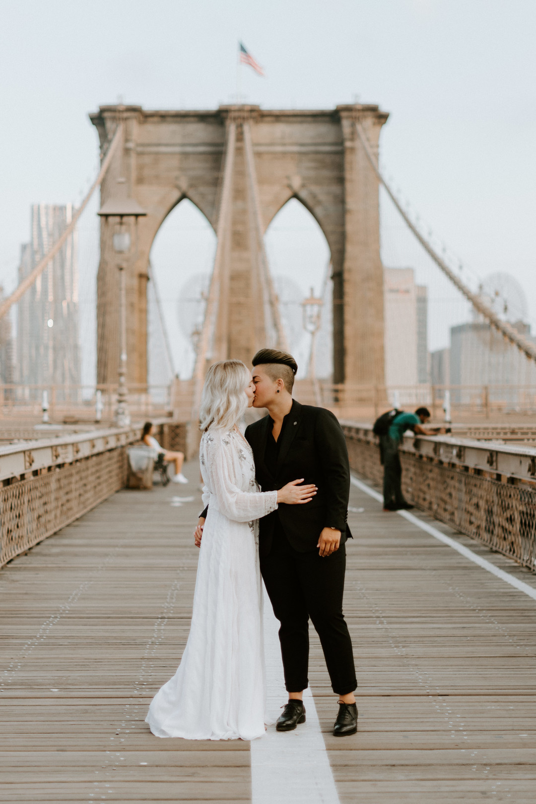 Sunrise engagement photos in Brooklyn, New York LGBTQ+ weddings two brides lesbian engagement long white dress NYC kiss