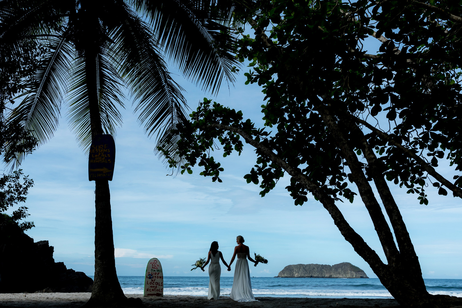 This couple needed a rain plan for their Costa Rica destination wedding LGBTQ+ weddings destination wedding two brides white dresses beach ocean palm tress