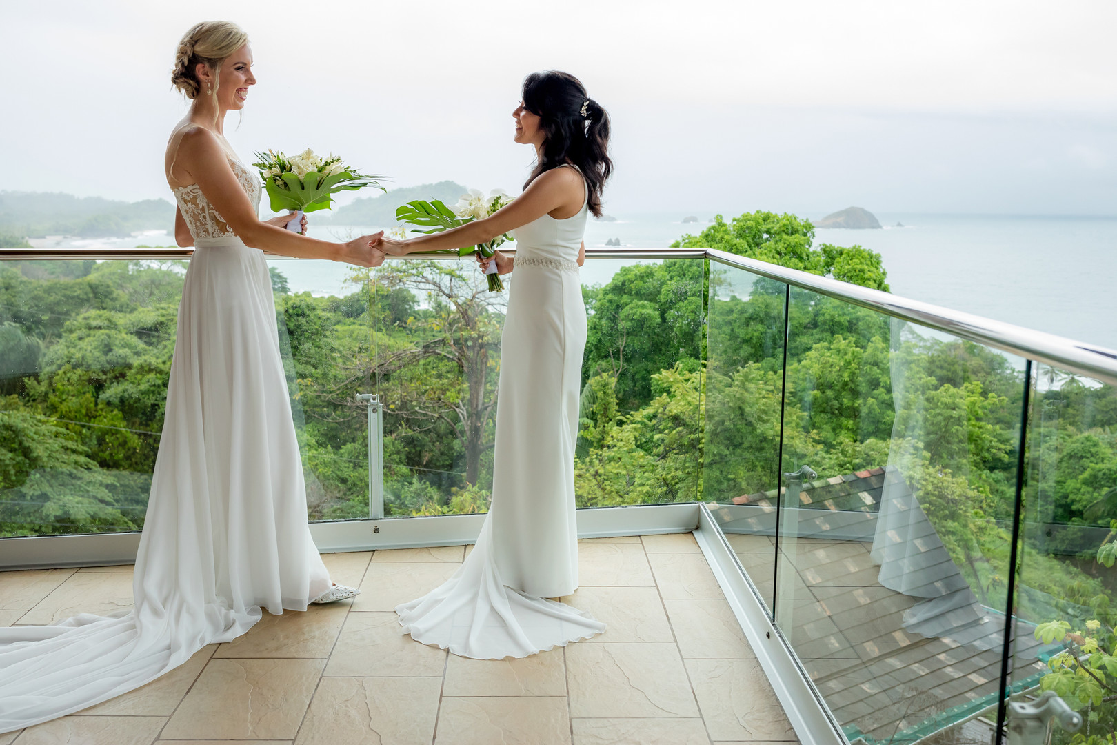 This couple needed a rain plan for their Costa Rica destination wedding LGBTQ+ weddings destination wedding two brides white dresses beach ocean palm trees first look