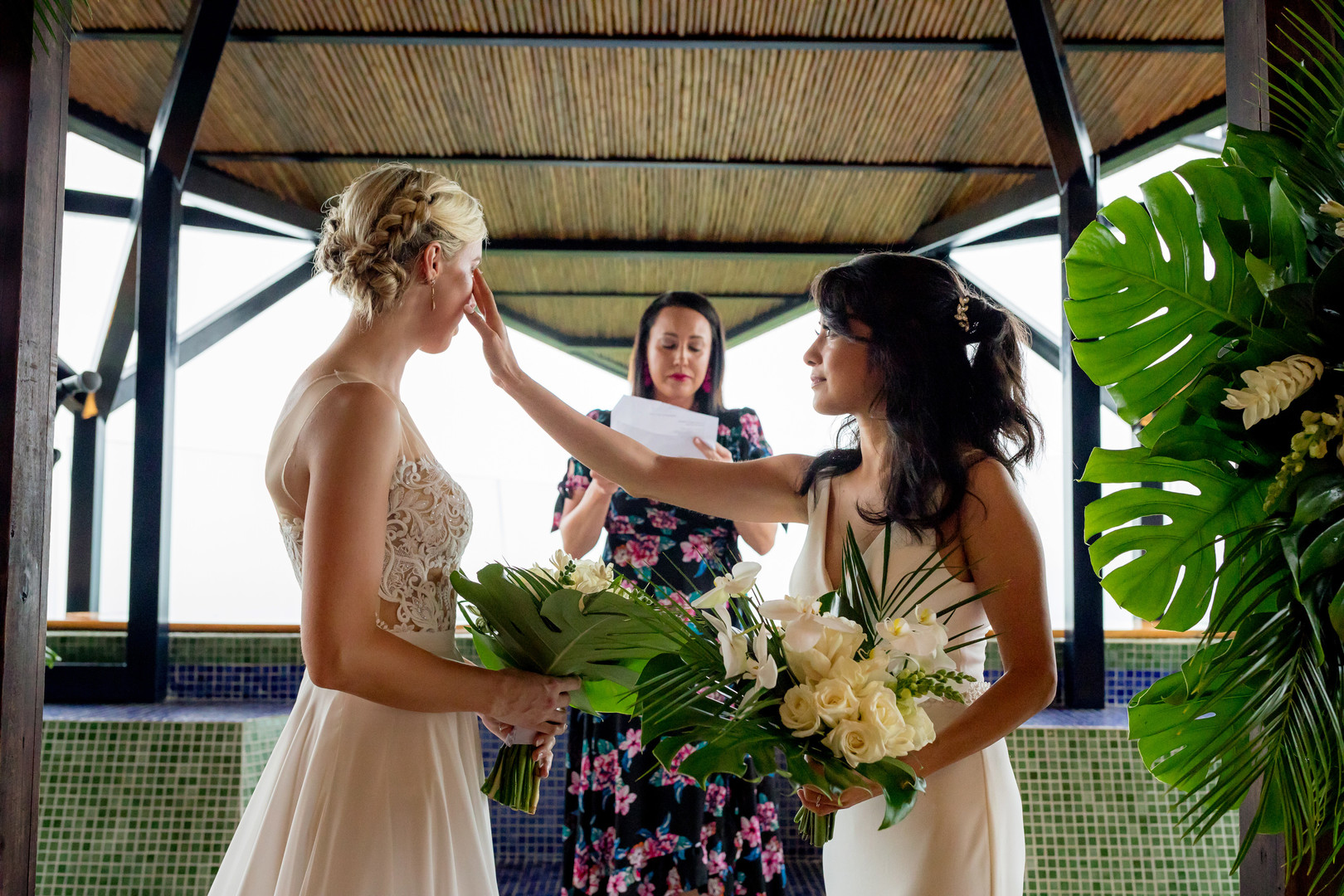 This couple needed a rain plan for their Costa Rica destination wedding LGBTQ+ weddings destination wedding two brides white dresses beach ocean palm trees vows