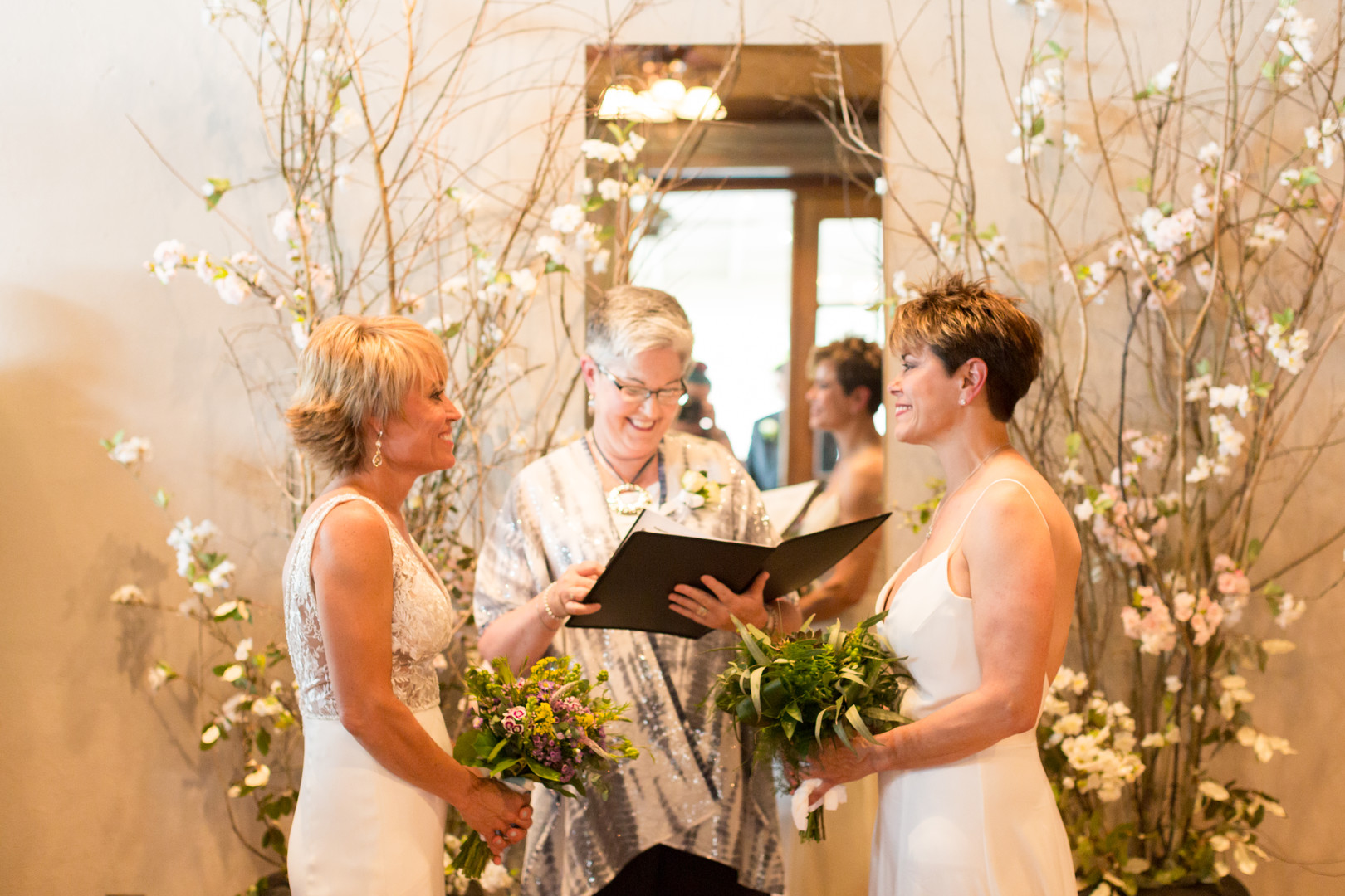 Intimate spring restaurant wedding in Newberry, South Carolina LGBTQ+ weddings two brides white dresses small wedding vows