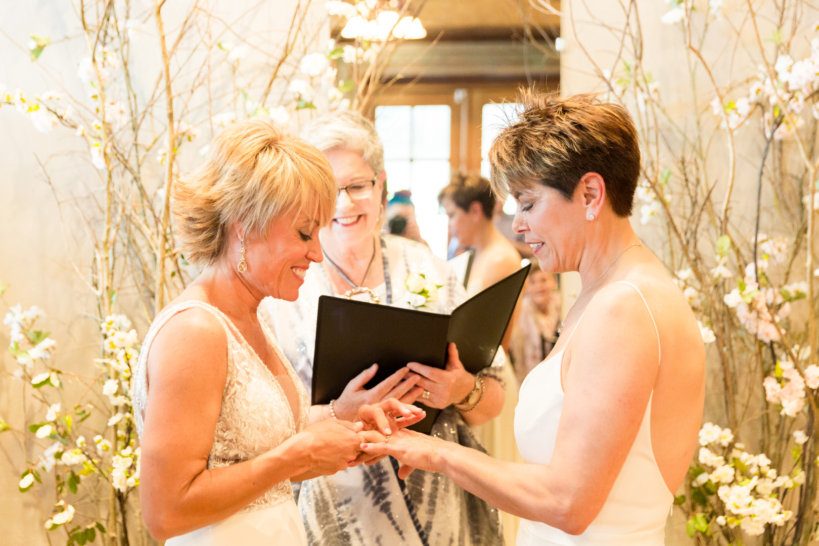 Intimate spring restaurant wedding in Newberry, South Carolina LGBTQ+ weddings two brides white dresses small wedding vows