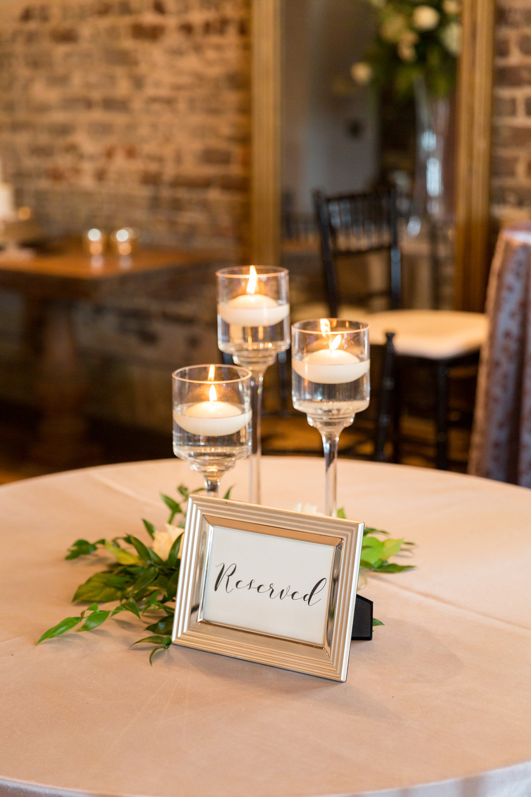 Intimate spring restaurant wedding in Newberry, South Carolina LGBTQ+ weddings two brides white dresses small wedding candles