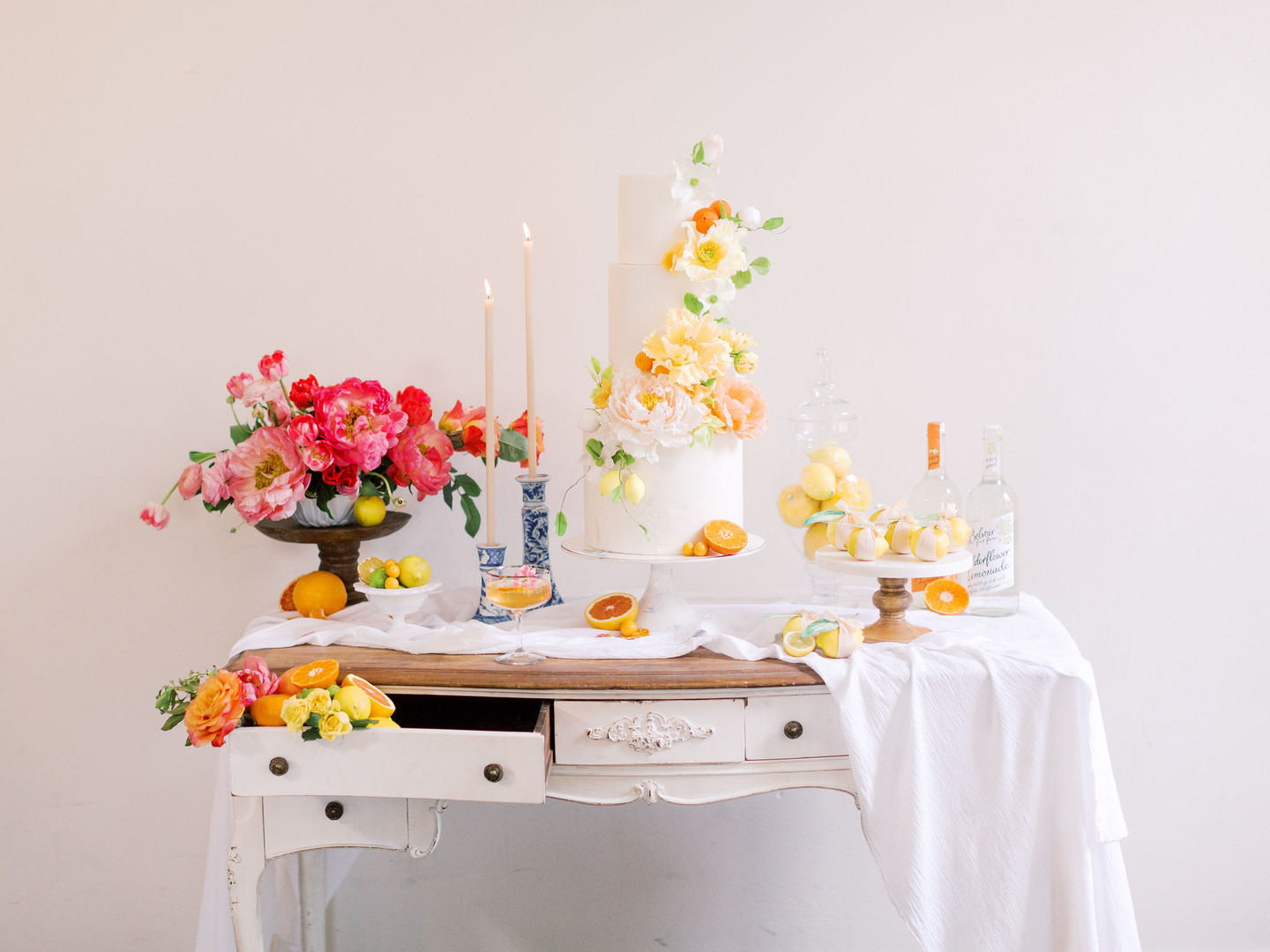 Summer citrus wedding inspiration at historic post office LGBTQ+ weddings two grooms gay wedding blue suit white gray suit orange blue bright colorful summery styled shoot decor cake