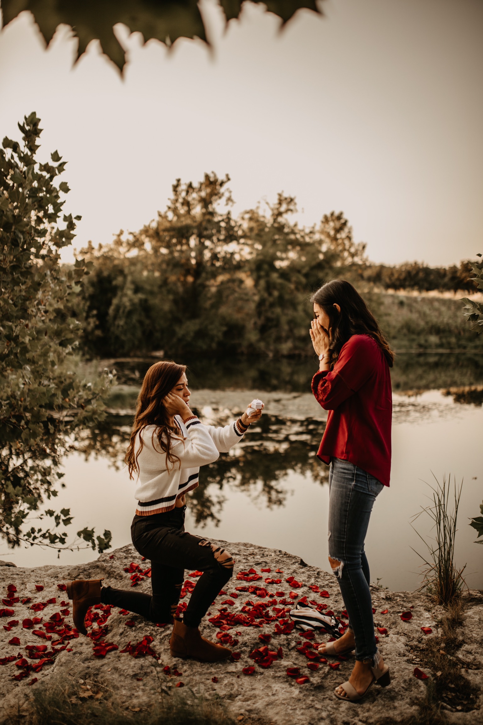 Fall photos turned surprise proposal in San Antonio, Texas moody romantic two brides rose petals outdoors water lake