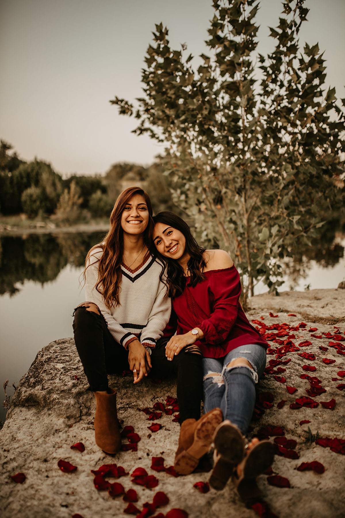 Fall photos turned surprise proposal in San Antonio, Texas moody romantic two brides rose petals outdoors water lake