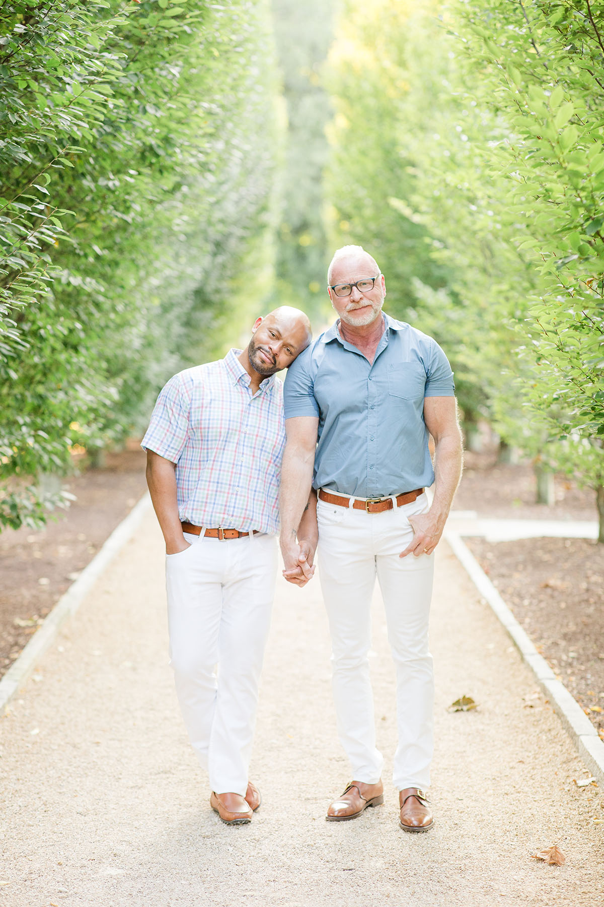 Garden engagement photos at the Franklin Park Conservatory LGBTQ+ weddings two grooms engagement gay outdoors nature holding hands