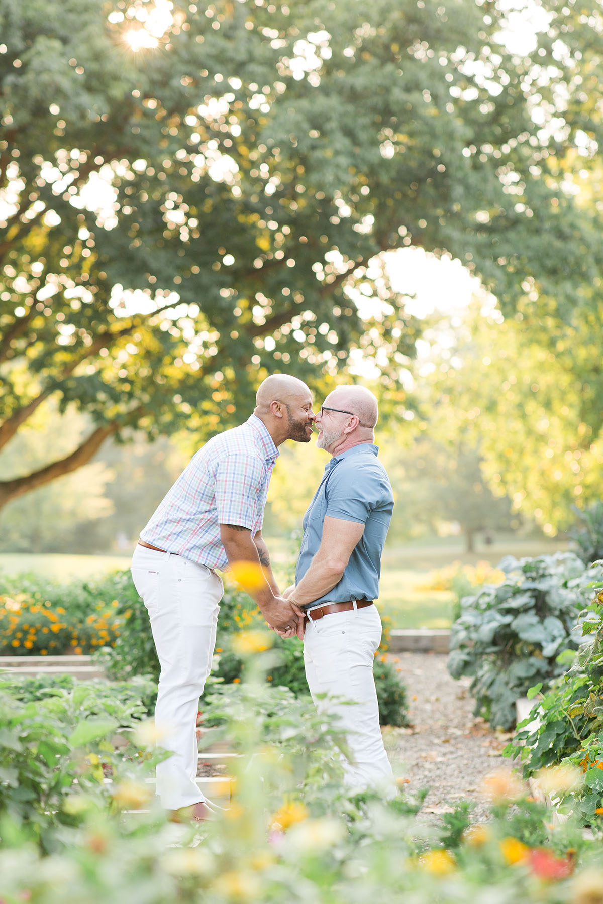 Garden engagement photos at the Franklin Park Conservatory LGBTQ+ weddings two grooms engagement gay outdoors nature kiss
