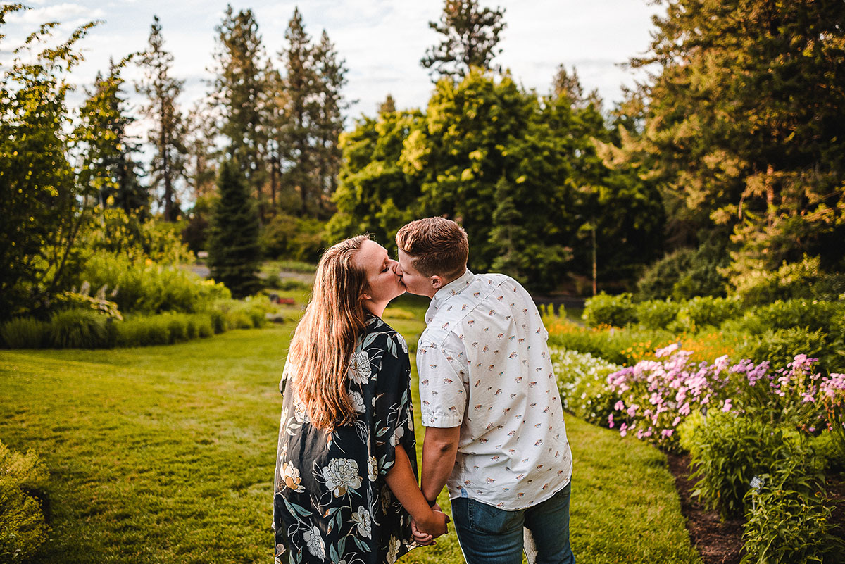 This couples' portrait session turned into the sweetest surprise proposal LGBTQ+ weddings engagements two brides Duncan Gardens Spokane Washington outdoor park engagement kiss