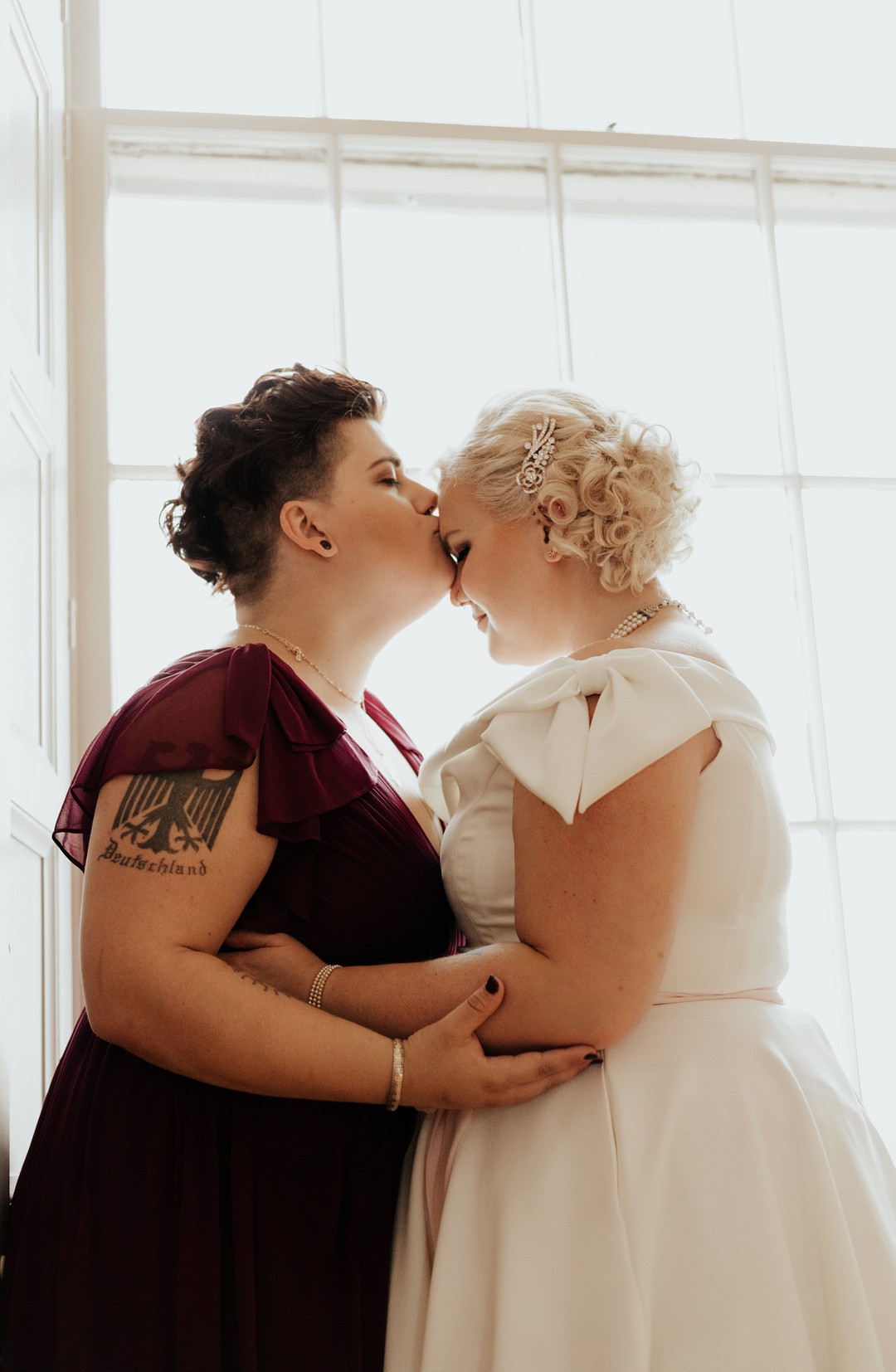 Vintage travel-inspired fall wedding in Iowa City, Iowa LGBTQ+ weddings lesbian wedding two brides alternative wedding kiss