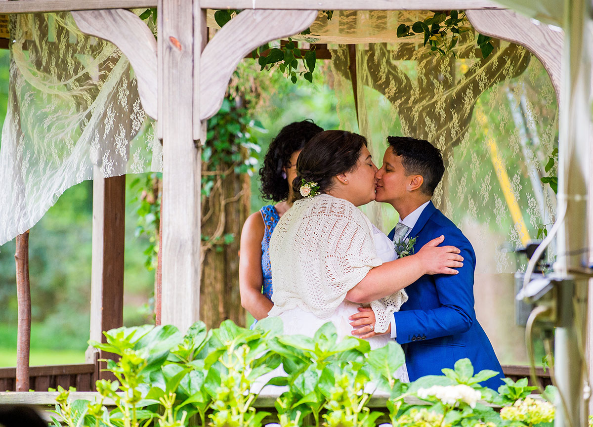 Community was at the heart of this floral summer wedding LGBTQ+ weddings two brides queer lesbian wedding Long Island New York Bindle and Keep vows kiss