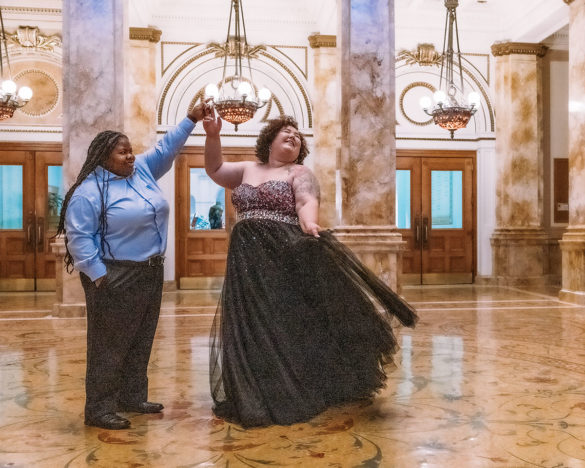 Romantic engagement photos at Milwaukee Central Public Library two brides tulle and glitter dress proposal dancing