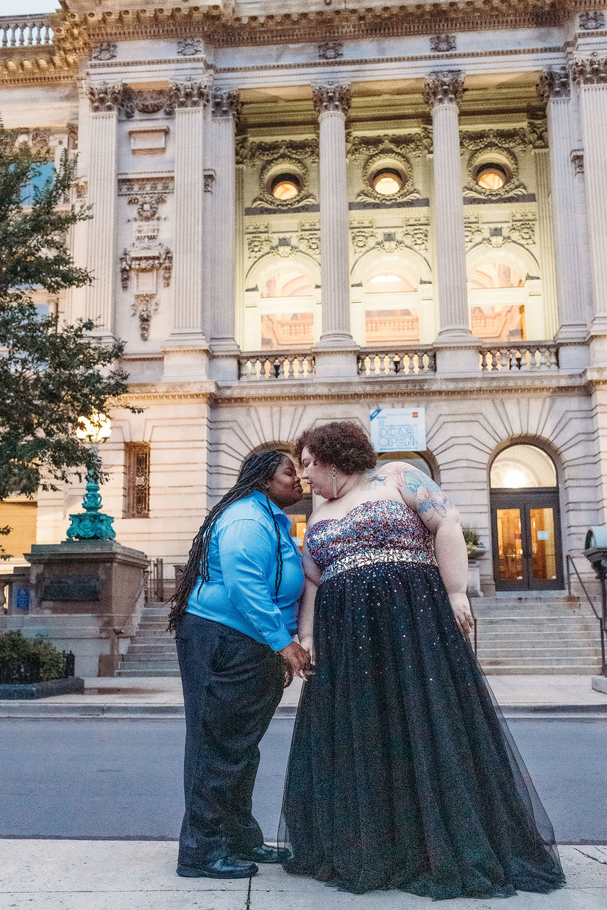 Romantic engagement photos at Milwaukee Central Public Library two brides tulle and glitter dress proposal