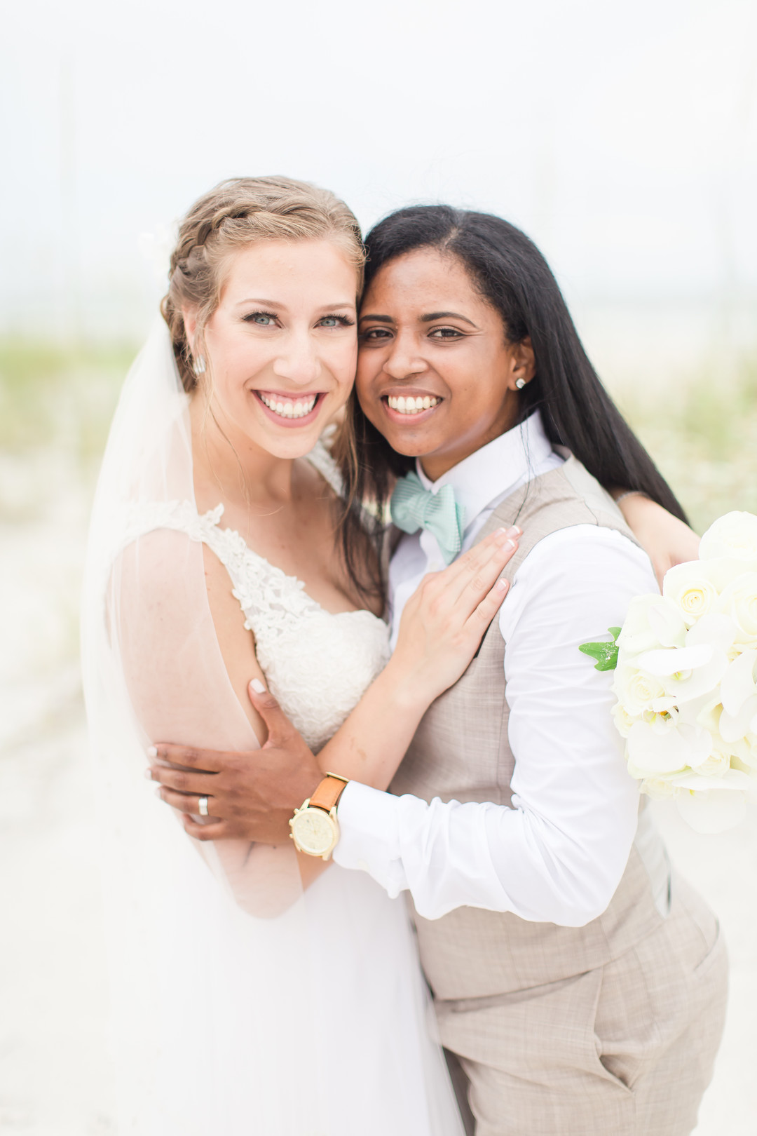 Tropical blue and green beach wedding in St. Petersburg, Florida two brides lesbian wedding white dress tan suit destination LGBTQ+ weddings