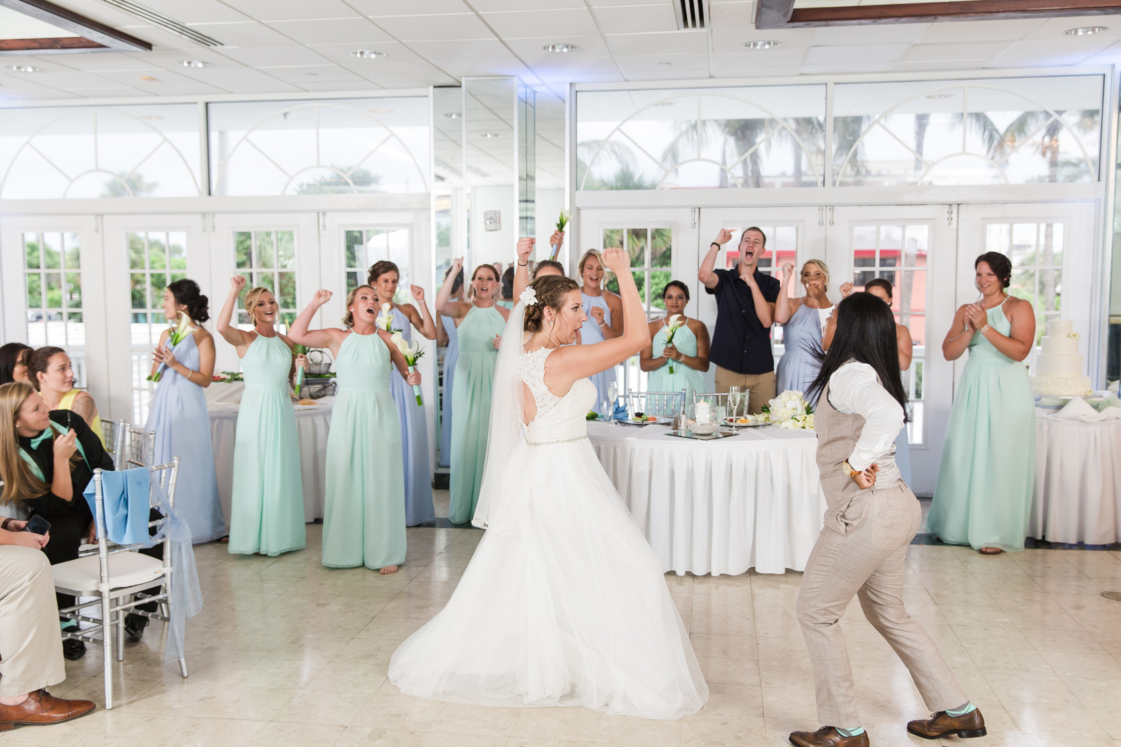 Tropical blue and green beach wedding in St. Petersburg, Florida two brides lesbian wedding white dress tan suit destination LGBTQ+ weddings dance