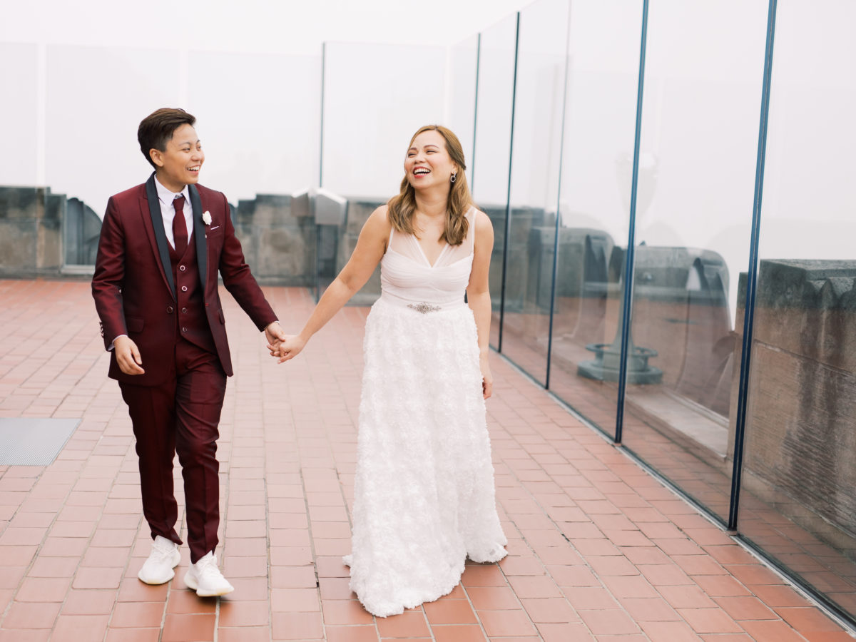 Romantic spring elopement at The Top of The Rock in New York City wine cranberry suit white dress New York City NYC two brides LGBTQ+ weddings lesbian gay wedding transcontinental destination