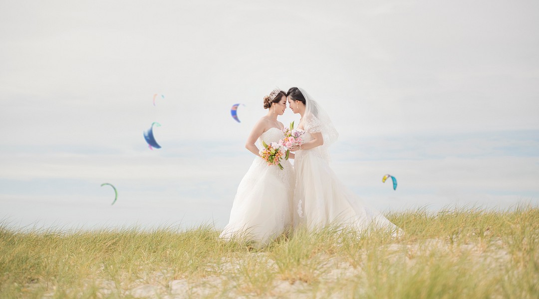 Destination beach yacht club wedding in South Australia LGBTQ+ weddings lesbian wedding two brides Chinese American white dresses