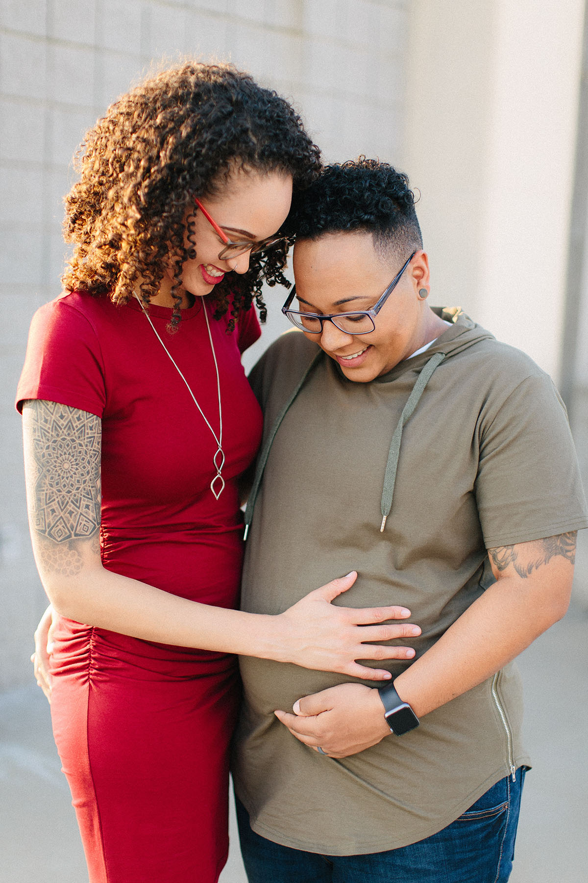 Sunset, books and basketball maternity photos LGBTQ+ family pregnancy new baby child two moms lesbian moms gay parents queer parenting