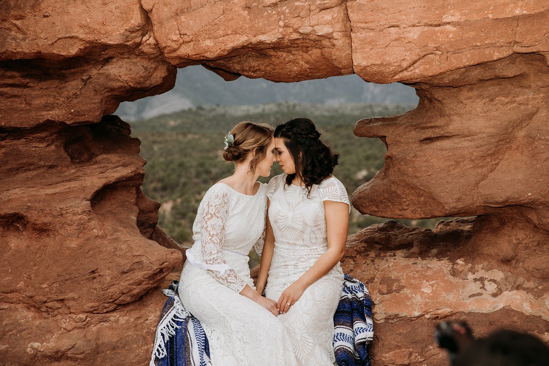 Epic spring Garden of the Gods elopement with dog attendants LGBTQ+ weddings intimate lesbian wedding two brides dogs sandstone formation cliffs