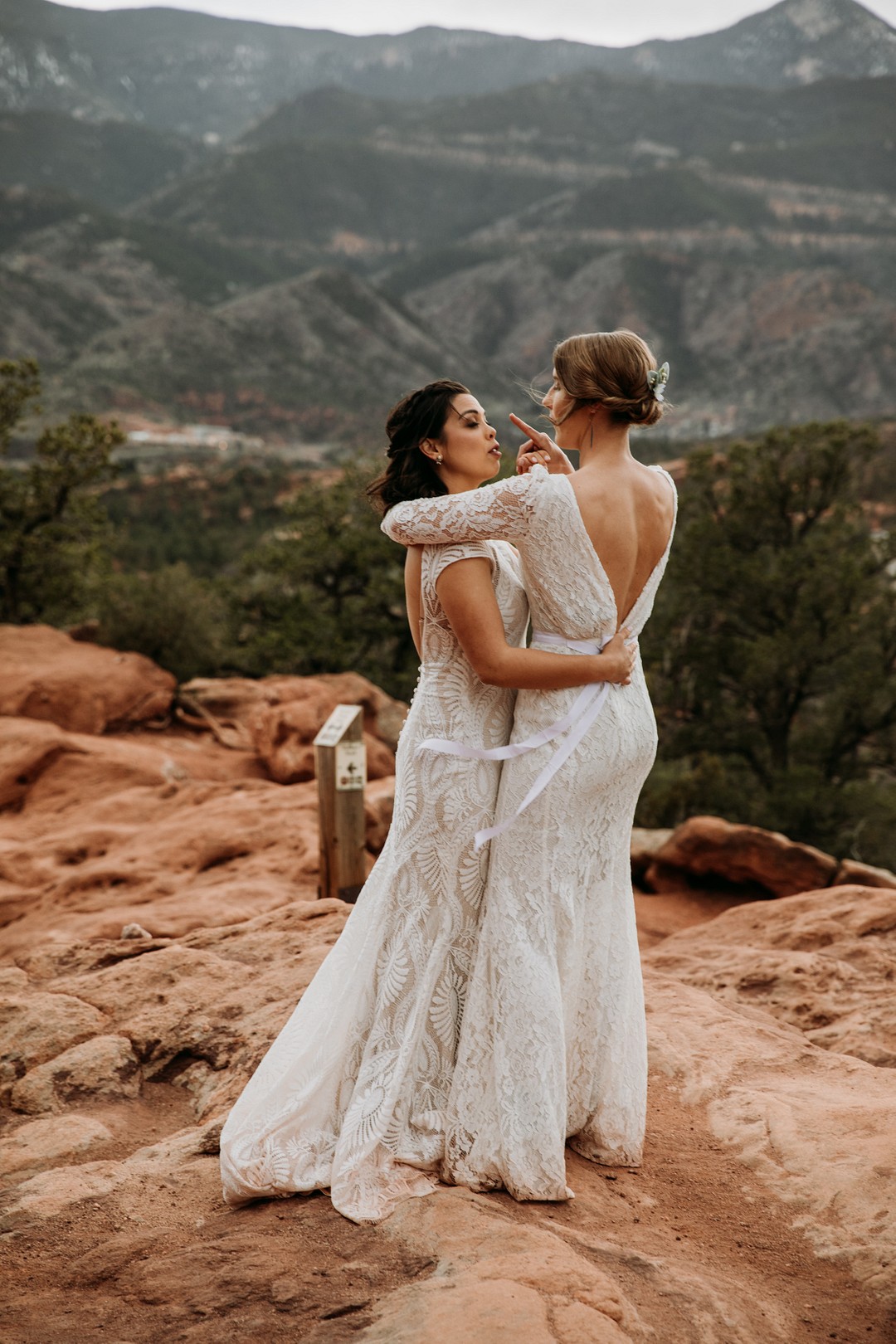 Epic spring Garden of the Gods elopement with dog attendants LGBTQ+ weddings intimate lesbian wedding two brides dogs sandstone formation cliffs dance