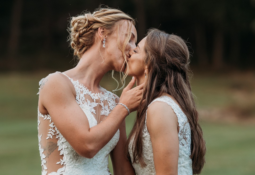 Rustic, elegant early fall wedding in Sabillasville, Maryland LGBTQ+ weddings lesbian wedding two brides long white dresses outdoors South Carolina Southern September wedding sunflowers kiss